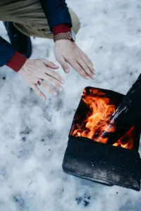 person warming hands on fire